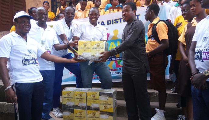 Rev Lawrence Ablorh (left) presenting books to Mr Alfred Asigbey
